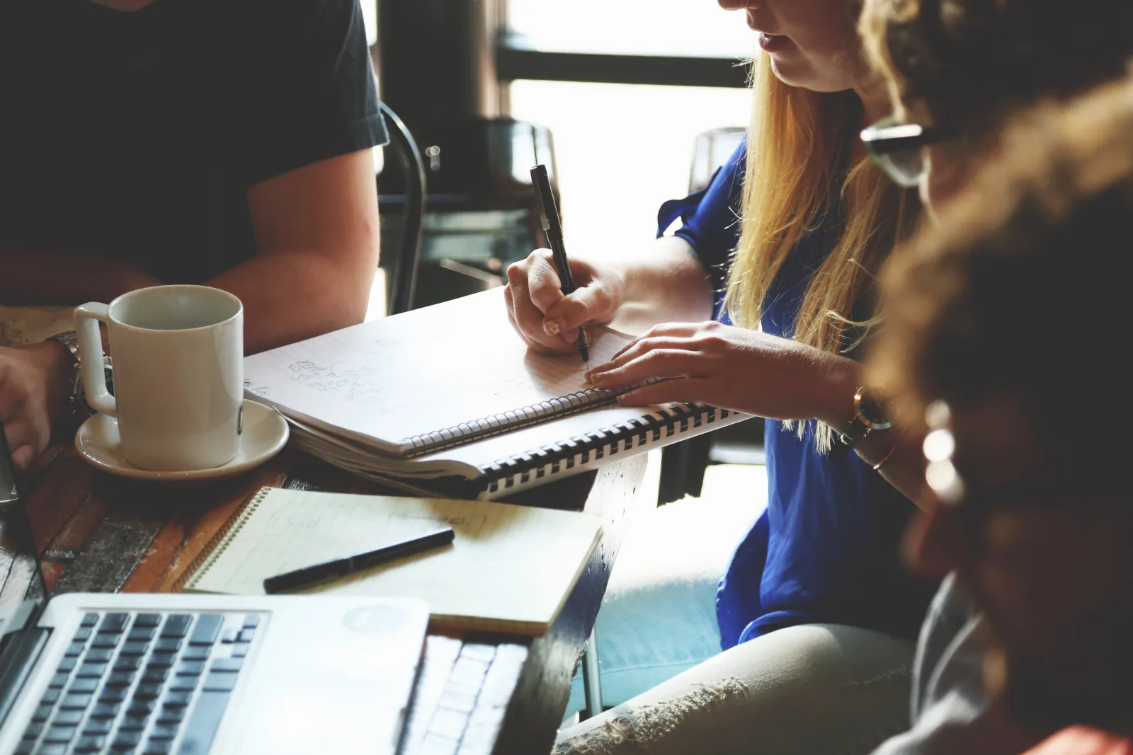Small-business team discussing remote working around a laptop